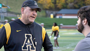 Head Coach Shawn Clark speaks to Asheville Citizen-Times sports reporter Evan Gerike after the AppState MountaineersÕ football practice at Appalachian State University in Boone, NC, on Wednesday, Oct. 23, 2024.