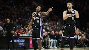Feb 6, 2025; Portland, Oregon, USA; Sacramento Kings guard Malik Monk (0) and guard Zach LaVine (8) talk during a break in the action against the Portland Trail Blazers at Moda Center. Mandatory Credit: Troy Wayrynen-Imagn Images