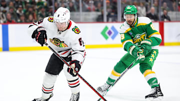 Dec 23, 2024; Saint Paul, Minnesota, USA; Chicago Blackhawks center Ryan Donato (8) skates with the puck as Minnesota Wild center Frederick Gaudreau (89) defends during the first period at Xcel Energy Center. Mandatory Credit: Matt Krohn-Imagn Images