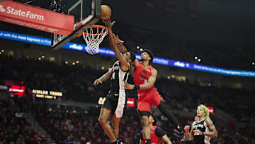 Dec 13, 2024; Portland, Oregon, USA; San Antonio Spurs guard Blake Wesley (14) is fouled during the first half by Portland Trail Blazers guard Scoot Henderson (00) at Moda Center. Mandatory Credit: Troy Wayrynen-Imagn Images