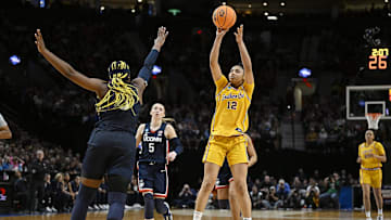 Apr 1, 2024; Portland, OR, USA; USC Trojans guard JuJu Watkins (12) shoots a jump shot during the second half against UConn Huskies forward Aaliyah Edwards (3) in the finals of the Portland Regional of the NCAA Tournament at the Moda Center. Mandatory Credit: Troy Wayrynen-Imagn Images