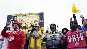 Ohio State Buckeyes and Michigan Wolverines fans react to a Hassan Haskins touchdown during the third quarter of the NCAA football game at Michigan Stadium in Ann Arbor on Saturday, Nov. 27, 2021.