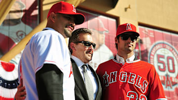 Angels owner Arte Moreno (center) poses for a photograph with first baseman Albert Pujols (left) and pitcher C.J. Wilson after a press conference at Angel Stadium on Dec. 10, 2011.