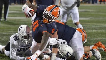 Nov 27, 2021; Champaign, Illinois, USA;  Illinois Fighting Illini running back Josh McCray (0) scores a touchdown against the Northwestern Wildcats during the second half at Memorial Stadium. Mandatory Credit: Ron Johnson-USA TODAY Sports