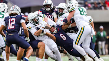 Nov 22, 2025; Tucson, Arizona, USA; Arizona Wildcats linebacker Taye Brown (6) attempts to take the ball out of the hands of the Baylor Bears during the fourth quarter of the game at Casino Del Sol Stadium. Mandatory Credit: Aryanna Frank-Imagn Images