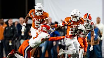 Texas Longhorns running back Jaydon Blue (23) evades a tackle from Clemson Tigers safety Khalil Barnes (7) to run the ball in for a touchdown in the fourth quarter as the Texas Longhorns play the Clemson Tigers in the first round of the College Football Playoffs at Darrell K Royal Texas Memorial Stadium in Austin, Texas, Dec. 21, 2024.