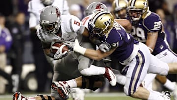 Nov 26, 2011, Seattle, WA, USA; Washington State Cougars running back Rickey Galvin (5) is tackled by Washington Huskies linebacker Cort Dennison (31) during the first half at CenturyLink Field. Mandatory Credit: Joe Nicholson-Imagn Images