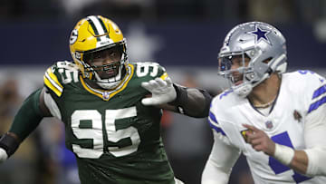 Green Bay Packers defensive tackle Devonte Wyatt (95) rushes Dallas Cowboys quarterback Dak Prescott (4) 