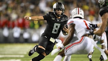 Oct 12, 2024; Eugene, Oregon, USA; Oregon Ducks quarterback Dillon Gabriel (8) carries the ball for a touchdown during the second half against the Ohio State Buckeyes at Autzen Stadium. Mandatory Credit: Troy Wayrynen-Imagn Images