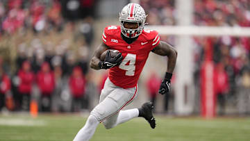 Ohio State Buckeyes wide receiver Jeremiah Smith (4) runs after making a catch during the NCAA football game against the Indiana Hoosiers at Ohio Stadium in Columbus on Monday, Nov. 25, 2024. Ohio State won 38-15.