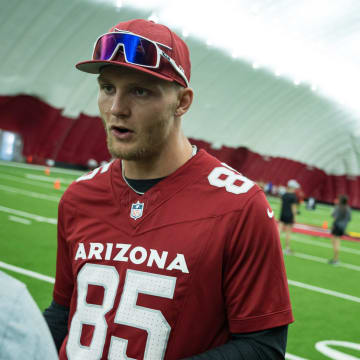 Tight end, Trey McBride speaks to a reporter during the girls flag football clinic at the Cardinals training facility on June 1, 2024 in Tempe, Ariz.