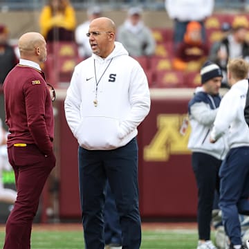 Nov 23, 2024; Minneapolis, Minnesota, USA; Minnesota Golden Gophers head coach P.J. Fleck and Penn State Nittany Lions head coach James Franklin talk before the game at Huntington Bank Stadium. Mandatory Credit: Matt Krohn-Imagn Images