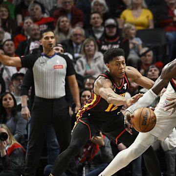 Mar 13, 2024; Portland, Oregon, USA; Portland Trail Blazers center Deandre Ayton (2) drives to the basket during the second half as he is double teamed by Atlanta Hawks center Clint Capela (15) and forward De'Andre Hunter (12) at Moda Center. Mandatory Credit: Troy Wayrynen-Imagn Images