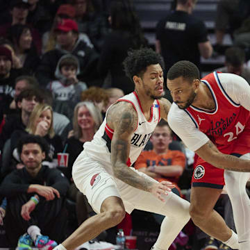 Jan 16, 2025; Portland, Oregon, USA; LA Clippers guard Norman Powell (24) looks for an opening during the second half against Portland Trail Blazers guard Anfernee Simons (1) at Moda Center. Mandatory Credit: Troy Wayrynen-Imagn Images