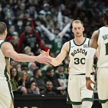 Mar 11, 2024; Portland, Oregon, USA; Boston Celtics forward Sam Hauser (30) celebrates with teammates guard Payton Pritchard (11), and forward Oshae Brissett (12) during the second half against the Portland Trail Blazers at Moda Center. Mandatory Credit: Troy Wayrynen-Imagn Images