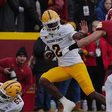 Arizona State Sun Devils quarterback Jeff Sims (2) battle for a few yards as Iowa State Cyclones' linebacker Caleb Bacon (26) attempts to tackle during the first quarter in the Big-12 showdown at jack Trice Stadium on Nov. 1, 2025, in Ames, Iowa.