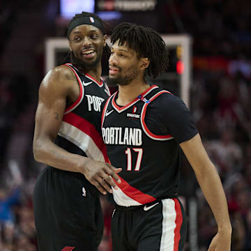 Feb 22, 2025; Portland, Oregon, USA; Portland Trail Blazers forward Jerami Grant (9) celebrates with Portland Trail Blazers guard Shaedon Sharpe (17) during the second half against the Charlotte Hornets at Moda Center. Mandatory Credit: Troy Wayrynen-Imagn Images