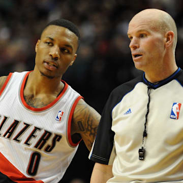 Jan. 04, 2014; Portland, OR, USA; Portland Trail Blazers point guard Damian Lillard (0) talks with referee Gary Zielinski (59) during the third quarter of the game against the Portland Trail Blazers at the Moda Center. The Sixers won the game 101-99. Mandatory Credit: Steve Dykes-Imagn Images