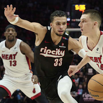 Jan 11, 2025; Portland, Oregon, USA; Miami Heat guard Tyler Herro (14) drives to the basket during the second half against Portland Trail Blazers forward Toumani Camara (33) at Moda Center. Mandatory Credit: Troy Wayrynen-Imagn Images