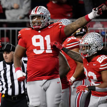 Nov 18, 2023; Columbus, Ohio, USA; Ohio State Buckeyes linebacker Steele Chambers (22) and defensive tackle Tyleik Williams (91) celebrate an interception by defensive end JT Tuimoloau (44) during the NCAA football game against the Minnesota Golden Gophers at Ohio Stadium.