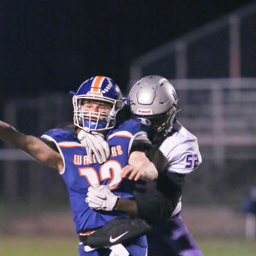 Joppatowne's Zion Elee wraps up Boonsboro QB Colin Telemeco as he releases the ball.