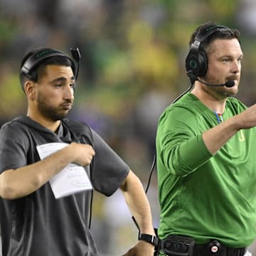 Sep 7, 2024; Eugene, Oregon, USA; Oregon Ducks head coach Dan Lanning signals his defense during the first half against the Boise State Broncos at Autzen Stadium. Mandatory Credit: Troy Wayrynen-Imagn Images