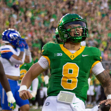 Oregon quarterback Dillon Gabriel, right, celebrates a first quarter touchdown against Boise State at Autzen Stadium in Eugene Sept. 7, 2024.