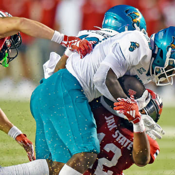 Coastal Carolina's Christian Washington tries to evade the tackle of Jacksonville State's Malcolm Jones during college football action at Burgess-Snow Field AmFirst Stadium in Jacksonville, Alabama August 29, 2024. (Dave Hyatt / Special to the Gadsden Times)