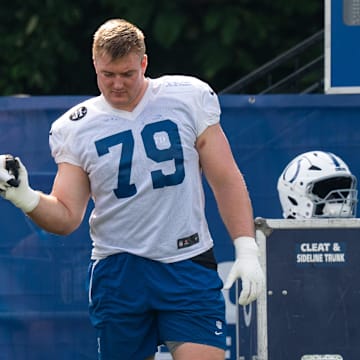 Indianapolis Colts offensive tackle Bernhard Raimann (79) gets a five from fellow offensive tackle Blake Freeland (73) on Friday, July 25, 2025, during training camp held at Grand Park in Westfield.