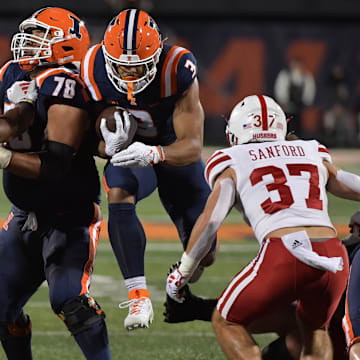 Oct 6, 2023; Champaign, Illinois, USA; Illinois Fighting Illini running back Kaden Feagin (3) runs through an opening in the Nebraska Cornhuskers defense during the first half at Memorial Stadium. Mandatory Credit: Ron Johnson-Imagn Images