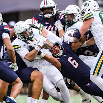 Nov 22, 2025; Tucson, Arizona, USA; Arizona Wildcats linebacker Taye Brown (6) attempts to take the ball out of the hands of the Baylor Bears during the fourth quarter of the game at Casino Del Sol Stadium. Mandatory Credit: Aryanna Frank-Imagn Images
