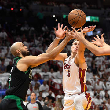Apr 29, 2024; Miami, Florida, USA; Miami Heat forward Nikola Jovic (5), and Miami Heat guard Jaime Jaquez Jr. (11) reach for the ball against Boston Celtics guard Derrick White (9) during the first quarter of game four of the first round for the 2024 NBA playoffs at Kaseya Center. Mandatory Credit: Michael Laughlin-USA TODAY Sports