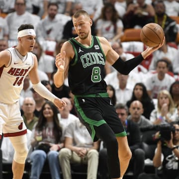 Apr 29, 2024; Miami, Florida, USA; Boston Celtics center Kristaps Porzingis (8) turns on Miami Heat guard Tyler Herro (14) during the first quarter of game four of the first round for the 2024 NBA playoffs at Kaseya Center. Mandatory Credit: Michael Laughlin-USA TODAY Sports