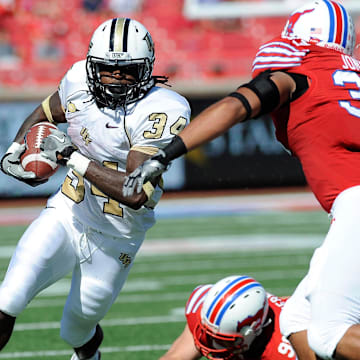 Oct 15, 2011; Dallas, TX, USA; UCF Knights running back Brynn Harvey (34) runs around the end against the Southern Methodist Mustangs during the first quarter at Gerald J. Ford Stadium.  Mandatory Credit: Jerome Miron-Imagn Images