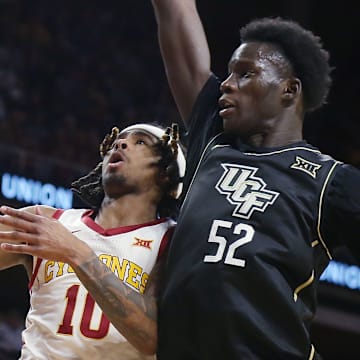 Iowa State Cyclones guard Keshon Gilbert (10) goes for a layup around UCF Knights forward Moustapha Thiam (52) during the first half in the Big-12 men’s basketball at Hilton Coliseum onTuesday, Jan. 21, 2025 in Ames, Iowa.