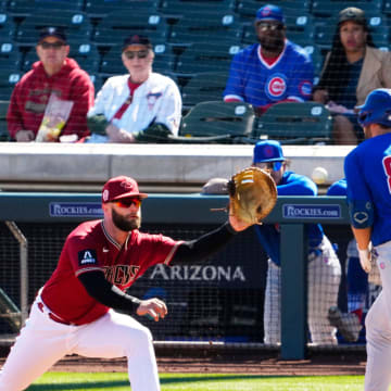 Arizona Diamondbacks first baseman Christian Walker (53) makes the out on Chicago Cubs Jake Slaughter (87) in the third inning during a spring training game at Salt River Fields on Feb. 27, 2023.