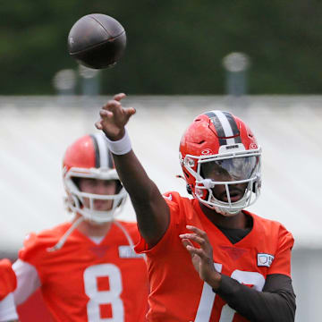 Browns quarterback Shedeur Sanders throws as QBs Dillon Gabriel (5) and Kenny Pickett look on during minicamp, Tuesday, June 10, 2025, in Berea.