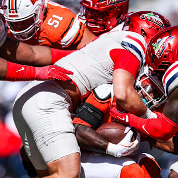 Oct 4, 2025; Tucson, Arizona, USA; Oklahoma State Cowboys gets tackled by the Arizona Wildcats during the third quarter of the game at Arizona Stadium. Mandatory Credit: Aryanna Frank-Imagn Images