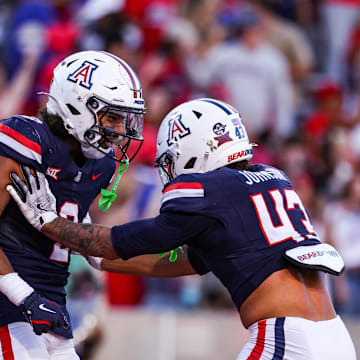 Nov 8, 2025; Tucson, Arizona, USA; Arizona Wildcats defensive backs Treydan Stukes and Dalton Johnson celebrate a win against the Kansas Jayhawks at the end of the game at Arizona Stadium. Mandatory Credit: Aryanna Frank-Imagn Images