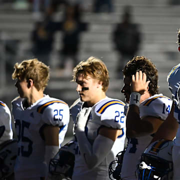 Catholic Memorial offensive tackle Owen Strebig (58) and teammates participate in pregame ceremonies before the game against Pius XI on Friday, September 29, 2023, at Raabe Stadium in Wauwatosa, Wisconsin.