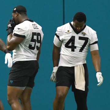Jacksonville Jaguars linebacker Josh Allen (41) jokes with teammates linebacker Myles Cole (59) and defensive end De'Shaan Dixon (47) during a break between drills. The Jacksonville Jaguars let most of the veterans off from participating in Monday's mandatory minicamp session held in the air conditioned enclosed field at EverBank Stadium's Miller Electric Center in Jacksonville, Fla. June 10, 2024. [Bob Self/Florida Times-Union]