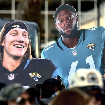 Oversized photos of Jacksonville Jaguars quarterback Trevor Lawrence (16) and teammate linebacker Josh Allen (41) are carried behind the crowd as they waited for the team to leave the stadium Friday morning. Hundreds of Jacksonville Jaguar fans waited outside the West entrance of TIAA Bank Field Friday morning, January 20, 2023, to cheer on the team as they headed to their cars to drive to the airport for their flight to Kansas City to play their AFC divisional round game against the Chiefs on