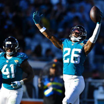 Jacksonville Jaguars safety Antonio Johnson (26) celebrates his late fourth quarter interception with linebacker Josh Allen (41) and linebacker Devin Lloyd (33). The Jacksonville Jaguars hosted the Carolina Panthers at EverBank Stadium in Jacksonville, FL Sunday, December 31, 2023. The Jaguars went in at the half with a 9 to 0 lead and came away with a 26 to 0 victory over the Panthers. [Bob Self/Florida Times-Union]