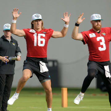 Jacksonville Jaguars quarterbacks Mac Jones (10), Trevor Lawrence (16) and C.J. Beathard (3) go through warm up exercises under the watchful eye of Lawrence's strength coach/nutritionist, Will Wynkoop during the second day of an NFL football training camp practice session Thursday, July 25, 2024 at EverBank Stadium's Miller Electric Center in Jacksonville, Fla.