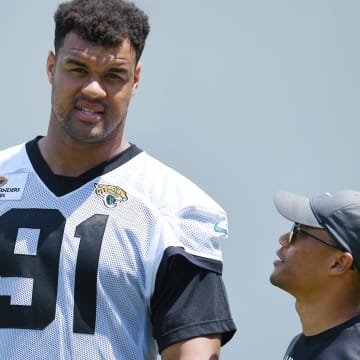 Jaguars director of football communications Dylan Morton talks with Jacksonville Jaguars defensive tackle Arik Armstead (91) at the end of the organized team activity session Monday, June 3, 2024 at EverBank Stadium's Miller Electric Center in Jacksonville, Fla.