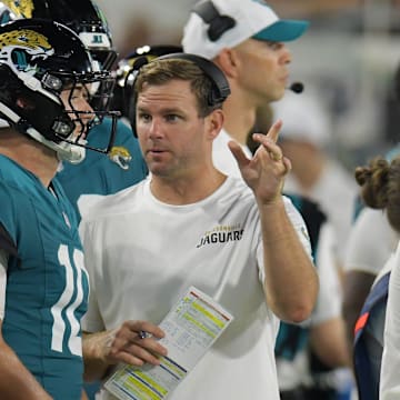 Jaguars offensive coordinator Press Taylor talks with Jacksonville Jaguars quarterback Mac Jones (10) on the sidelines during second half action of Saturday's game against the Chiefs. The Jaguars came away with a 26 to 13 victory over the Kansas City Chiefs. The Jacksonville Jaguars hosted the Kansas City Chiefs in the Jaguars first preseason game of the season Saturday, August 10, 2024 at EverBank Stadium in Jacksonville, Fla. [Bob Self/Florida Times-Union]