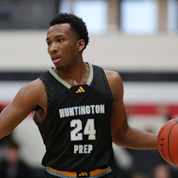 Huntington Prep guard Darryn Peterson takes the ball up the court during the first half at Canton Memorial Field House, Saturday, Feb. 17, 2024.