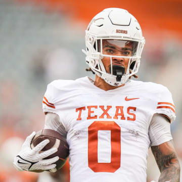 April 20, 2024; Austin, Texas, USA: Texas White team wide receiver DeAndre Moore Jr. (0) runs the ball in for a touchdown in the first quarter of the Longhorns' spring Orange and White game at Darrell K Royal Texas Memorial Stadium. Mandatory Credit: Sara Diggins-USA Today Sports via American Statesman