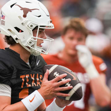 Texas Longhorns quarterback Arch Manning (16) looks for a pass while warming up ahead of the Longhorns' spring Orange and White game at Darrell K Royal Texas Memorial Stadium in Austin, Texas, April 20, 2024.