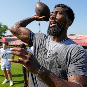 Louisville native Nate Hobbs works with aspiring young football players at his football camp at Waggener High School in 2024.